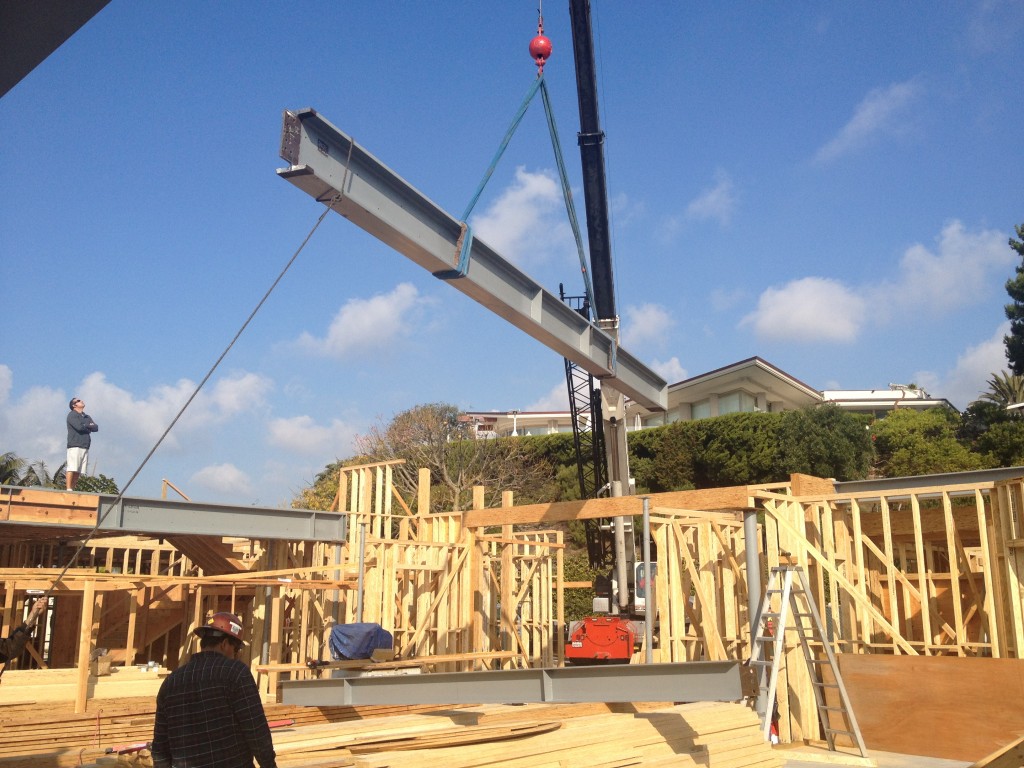 Steel beam install over wood-framed residential construction