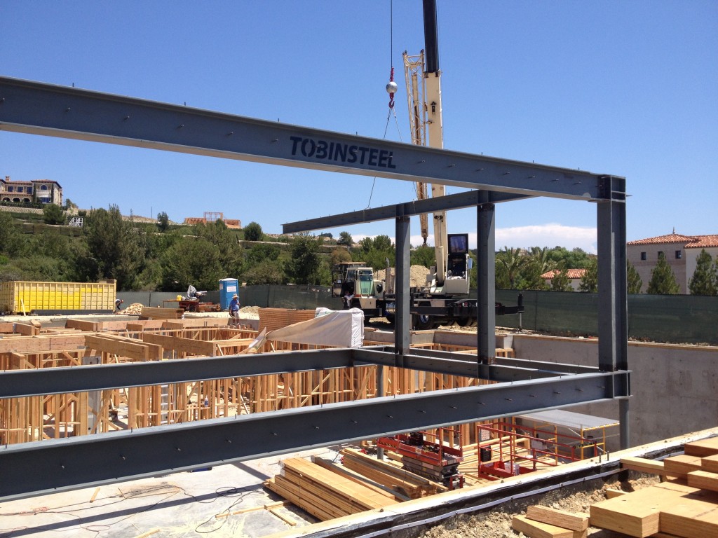 Tobin Steel beam being set by crane, Tobin Steel logo stamped on the beam