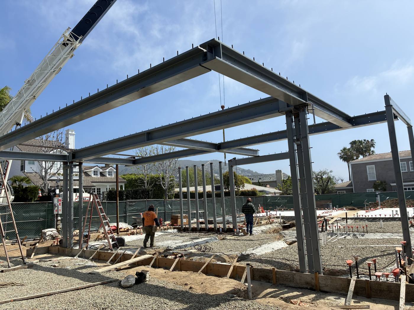 Steel frame install for large residential construction with crane