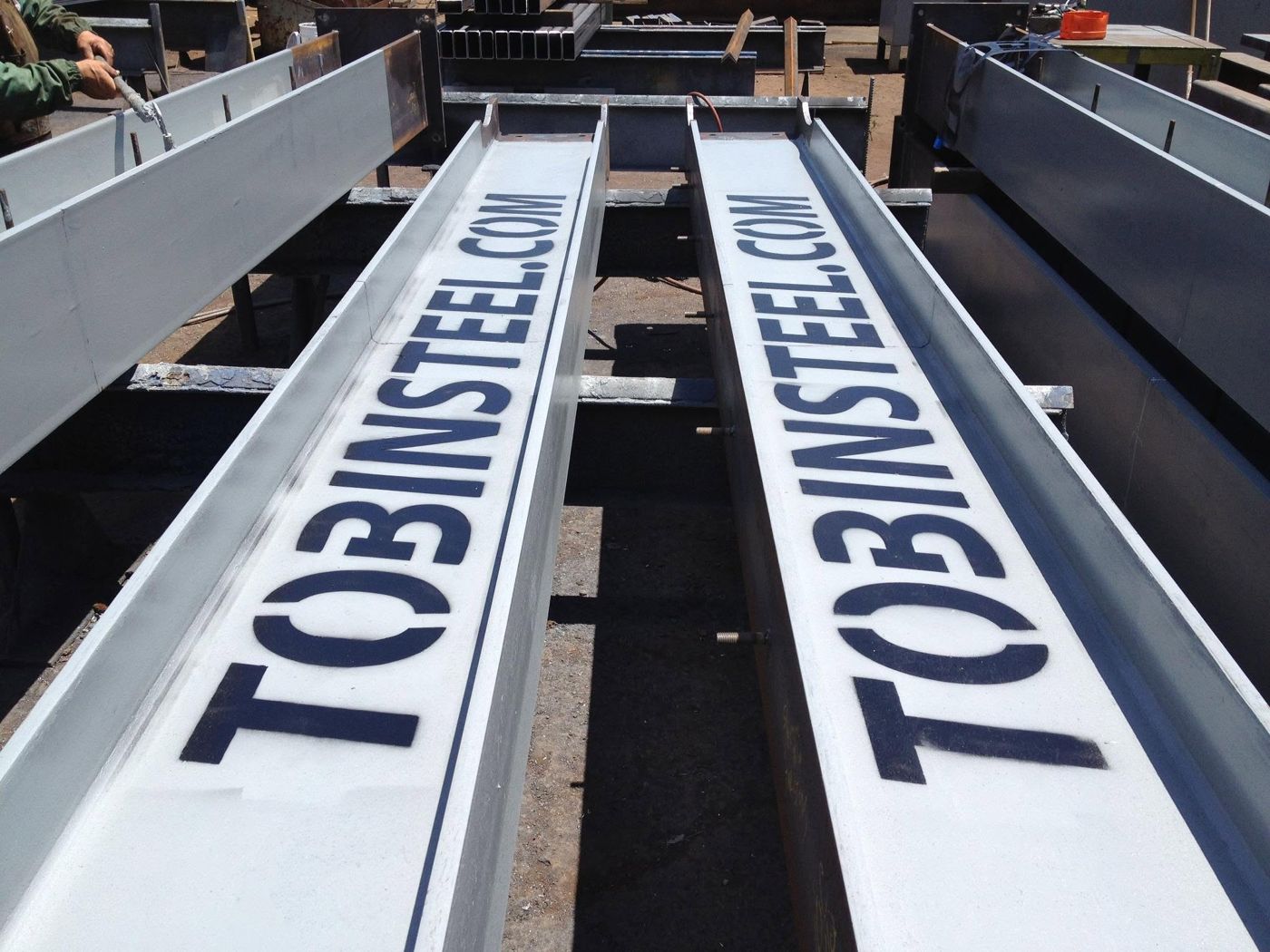 Beams stenciled with TOBINSTEEL.COM in the Santa Ana yard