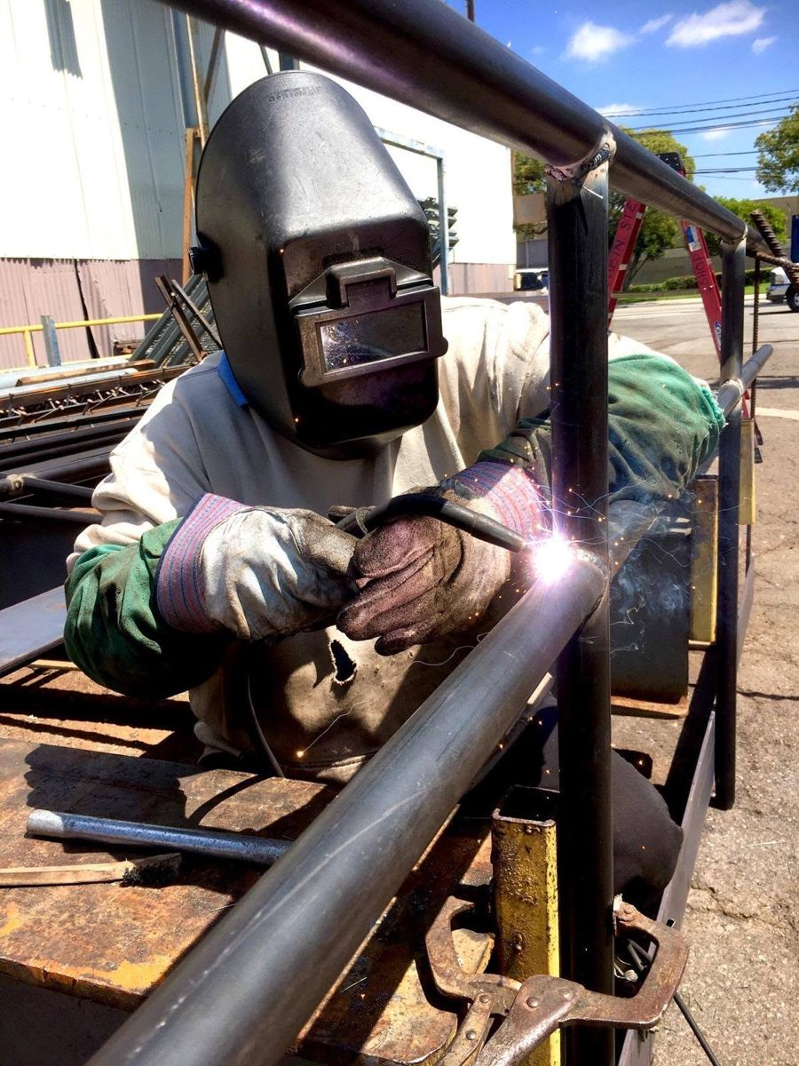 Tobin Steel welder fabricating a steel handrail in the yard