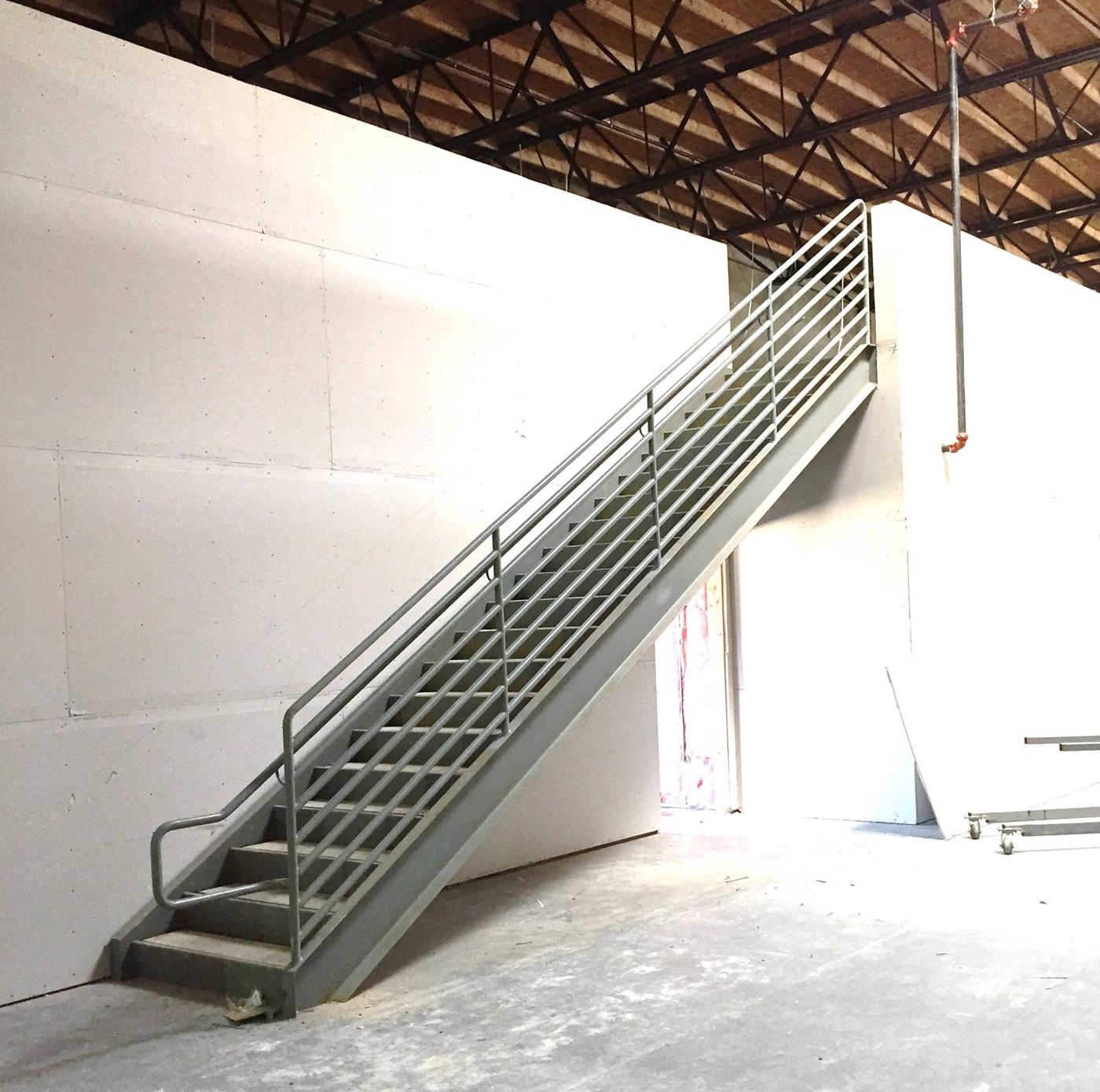 Interior steel stair with pipe railing